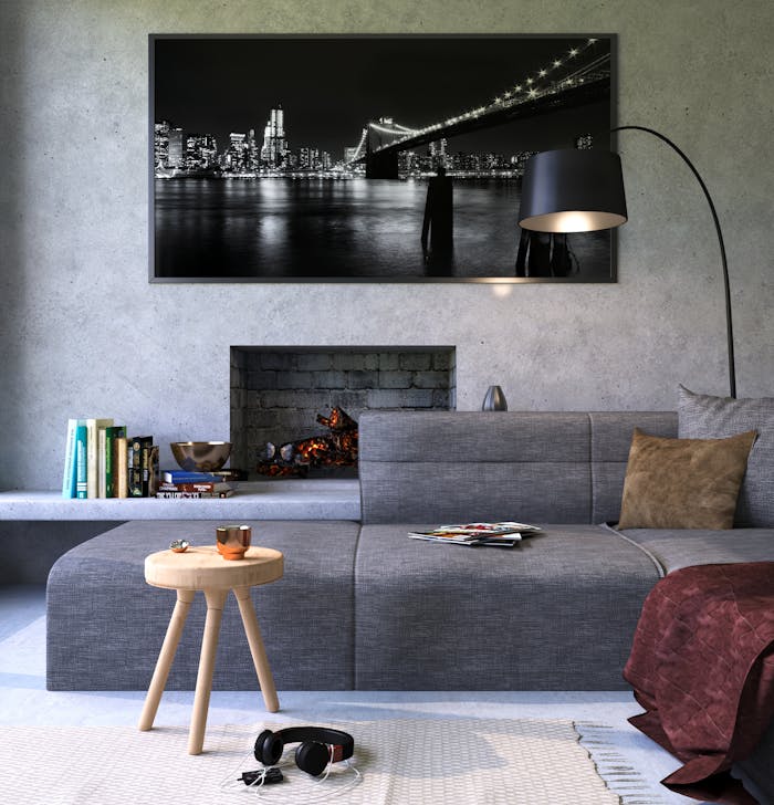 Modern gray living room featuring a fireplace and cityscape artwork, creating a cozy ambiance.